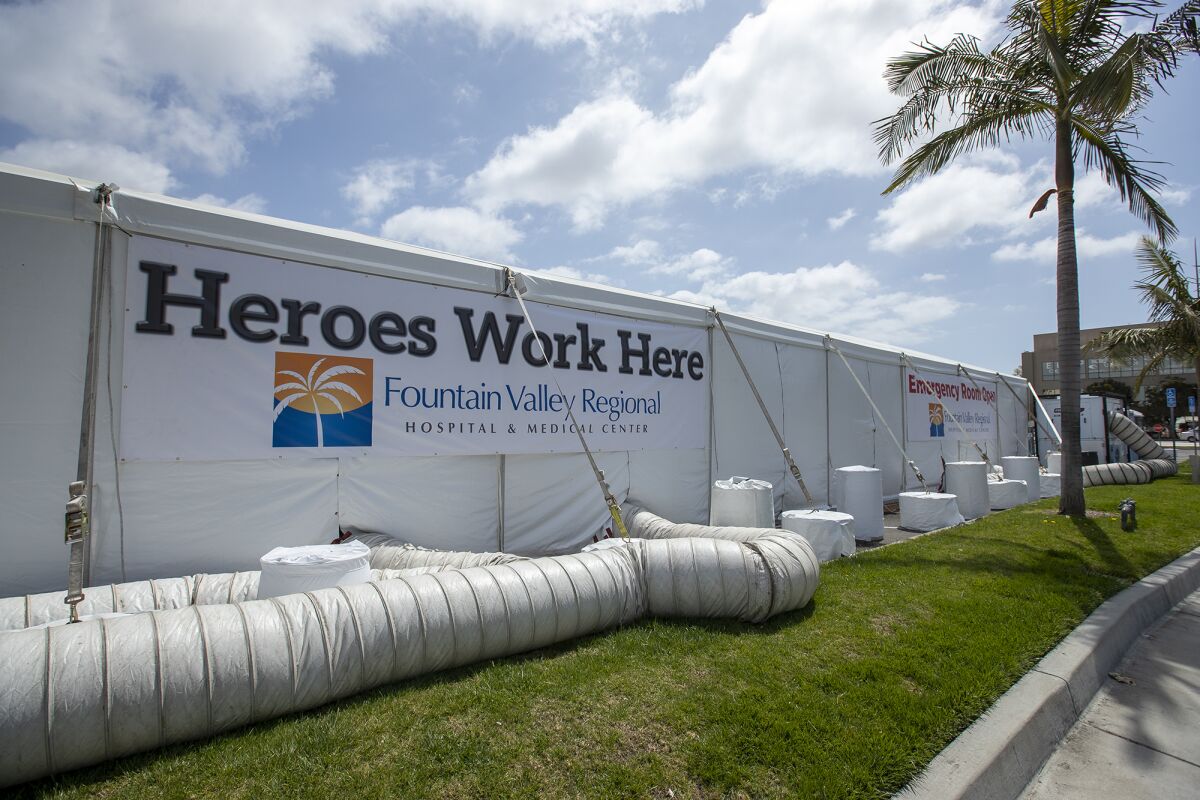 A tent outside the emergency room of the Fountain Valley Regional Hospital & Medical Center is used to screen people for coronavirus symptoms before allowing them inside the hospital on April 2.