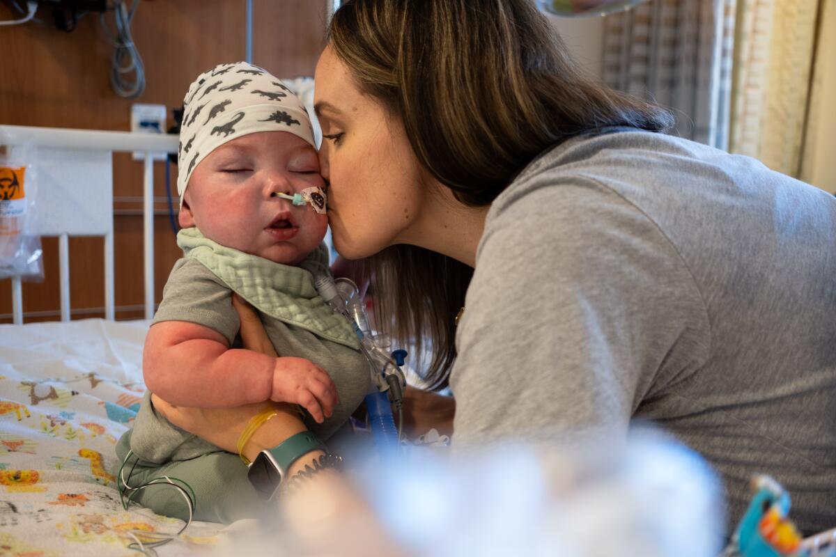 Caitlin Martin kisses her son Connor in the neonatal intensive care unit at Children's Hospital of Orange County.