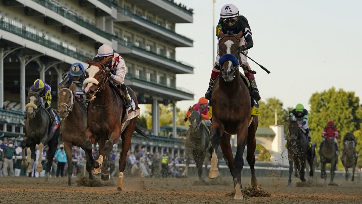 Jockey John Velazquez rides Authentic, right, to victory at the Kentucky Derby on Sept. 5.
