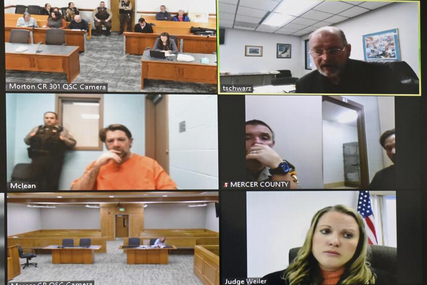 In this frame grab from video, Ian Cramer, middle left, makes his initial court appearance via a video link from from the McLean County jail in Washburn, N.D., Friday, Dec. 8, 2023. At top right is Mercer County State's Attorney Todd Schwarz, and at bottom right is South Central District Judge Bobbi Weiler. (Tom Stromme/The Bismarck Tribune via AP)