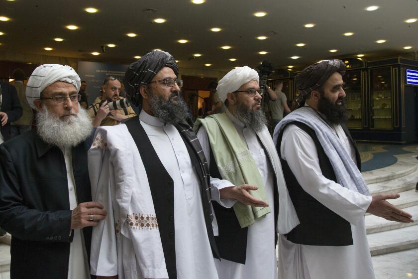 FILE - In this May 28, 2019, file photo, Mullah Abdul Ghani Baradar, the Taliban group's top political leader, second left, arrives with other members of the Taliban delegation for talks in Moscow, Russia. U.S. peace envoy Zalmay Khalilzad held on Saturday, Dec. 7, 2019 the first official talks with Afghanistan's Taliban since last September when President Donald Trump declared a near-certain peace deal with the insurgents dead. (AP Photo/Alexander Zemlianichenko, File)