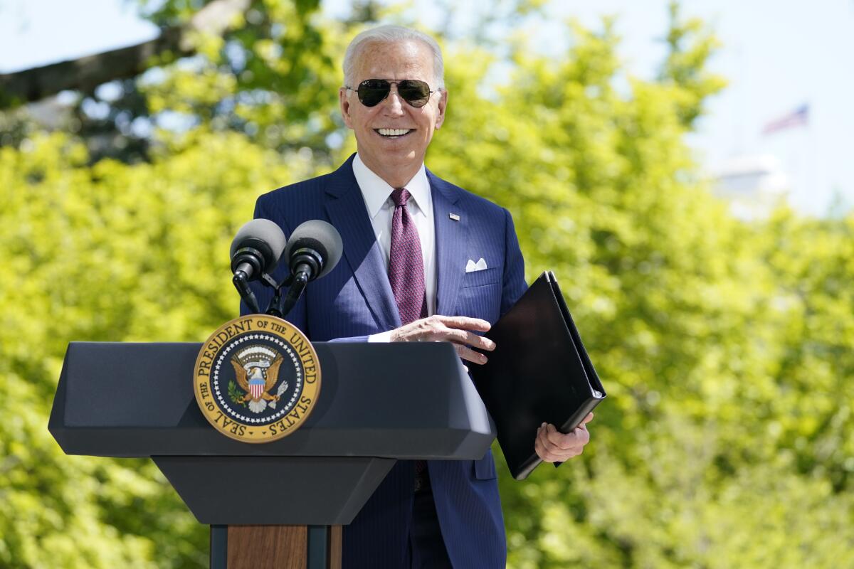 President Joe Biden at a podium on the North Lawn of the White House.