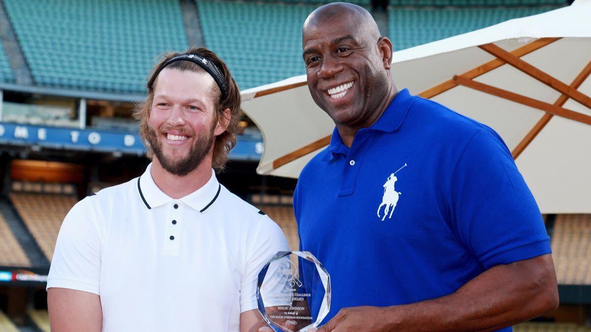 Dodgers pitcher Clayton Kershaw, left, and Magic Johnson at Kershaw's 5th Annual Ping Pong 4 Purpose Celebrity Tournament at Dodger Stadium on Thursday.