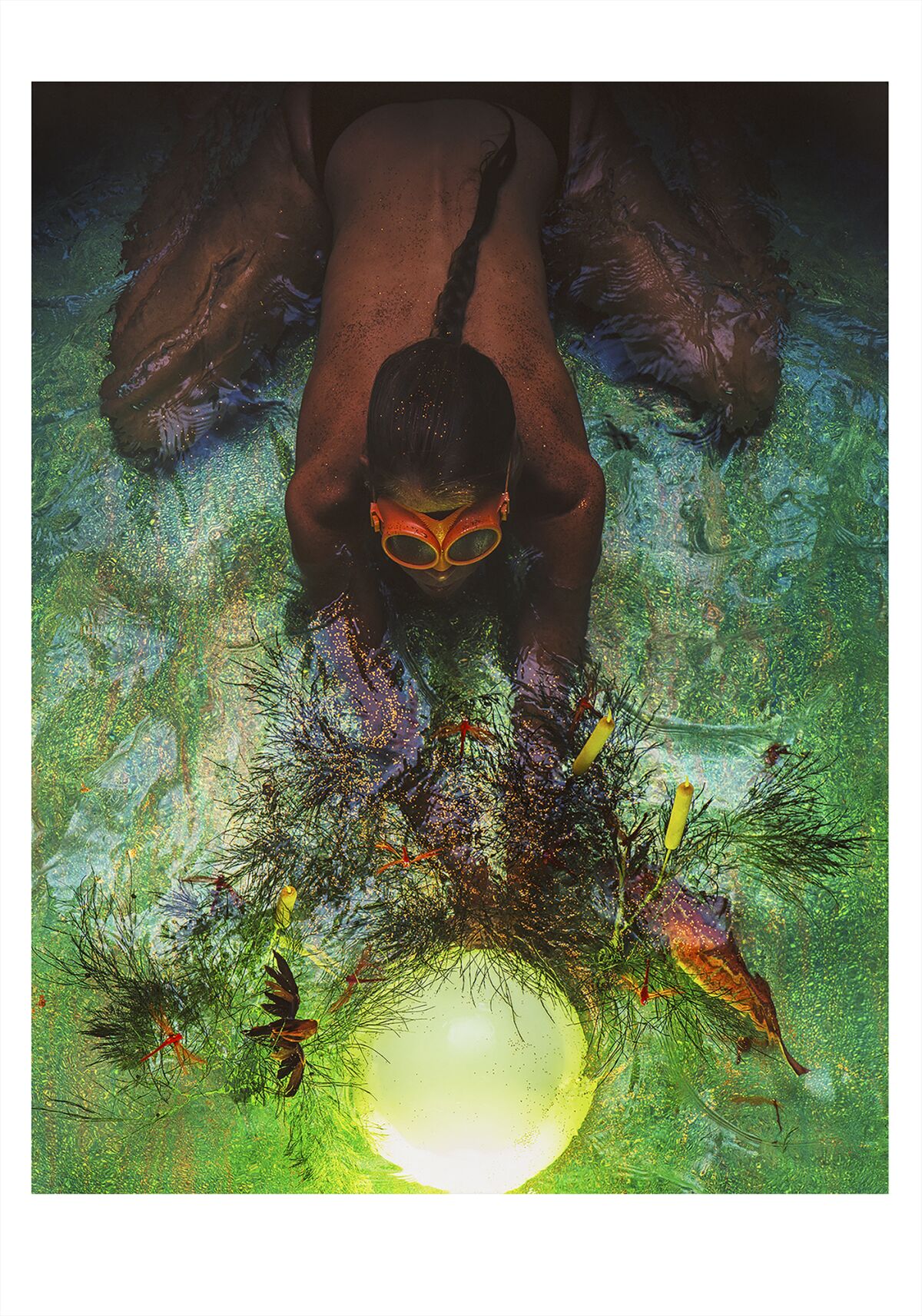 A person swims underwater in goggles in this photographic portrait by Suda House.