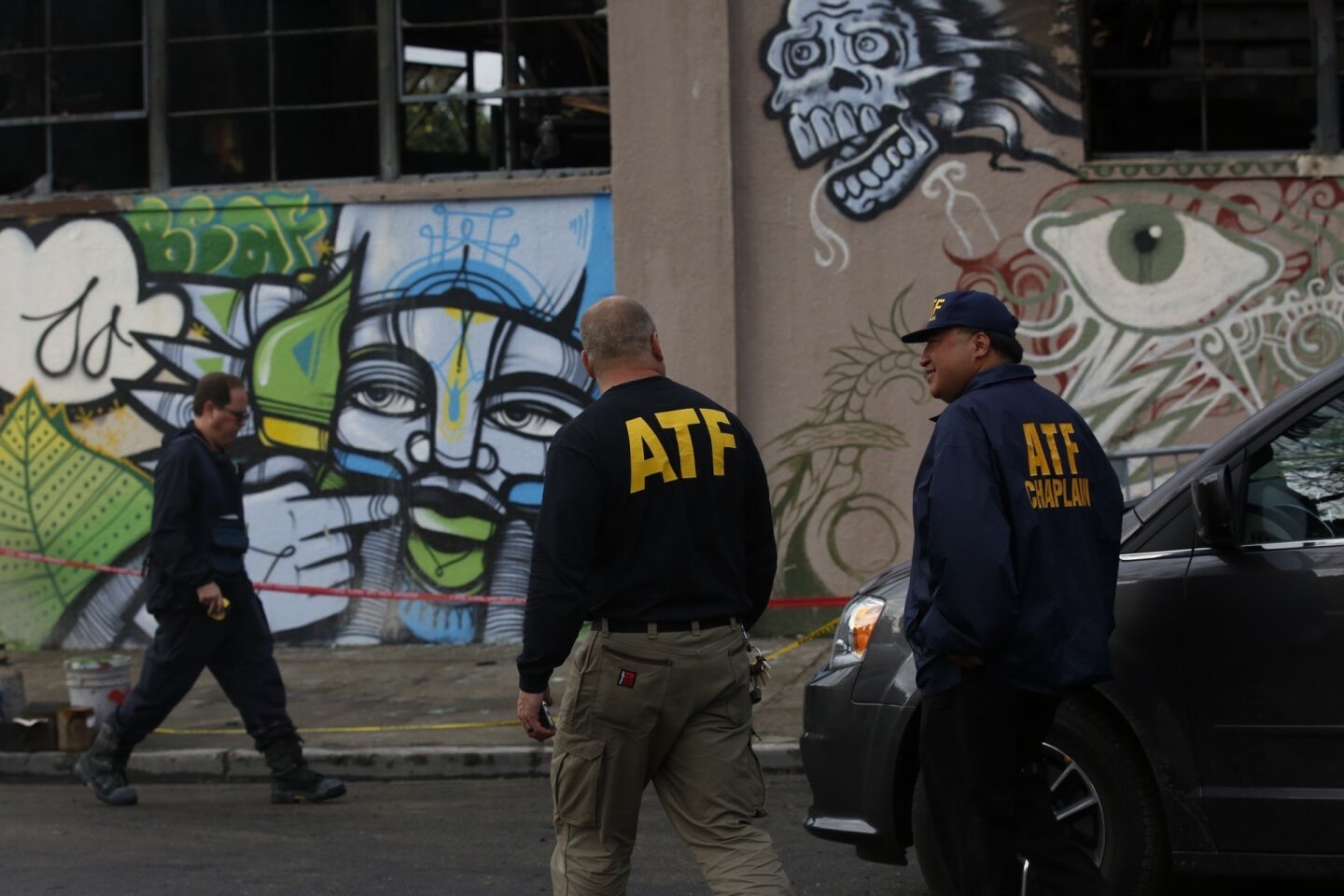 ATF agents map the scene of the fire investigation Friday at the Ghost Ship warehouse in Oakland. (Francine Orr/ Los Angeles Times)