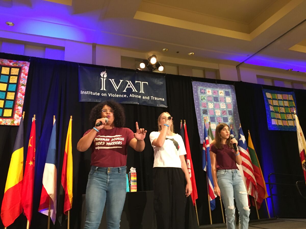 Students Marisol Garrido, Payton Francis and Sofia Rothenberg, survivors of the deadly school shooting in Parkland Florida, perform songs about their experience at the 24th International San Diego Summit on Violence, Abuse and Trauma across the Lifespan Sunday.