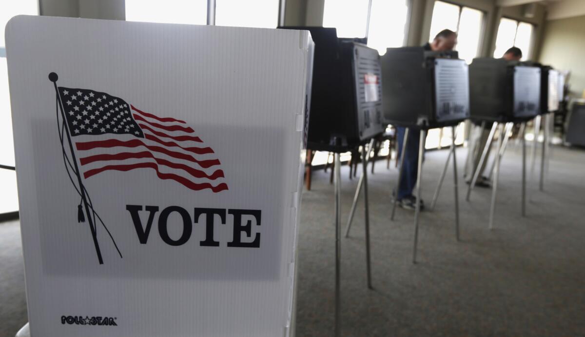 Primary voters cast their ballot in Hinsdale, Ill., in March.