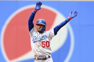 Los Angeles Dodgers' Mookie Betts celebrates hitting a two-run double during the eighth inning.