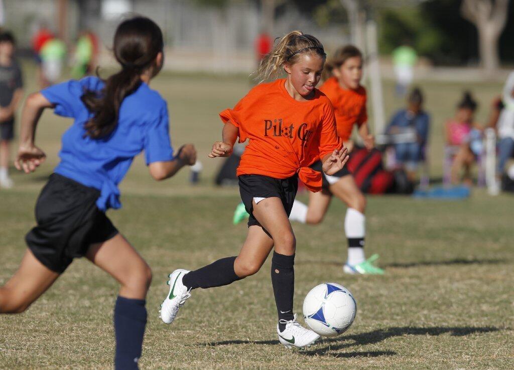 Karli Rask dribbles the ball upfield on a breakaway in a Daily Pilot Cup girls 3-4 gold division game against Our Lady Queen of Angels Wednesday.