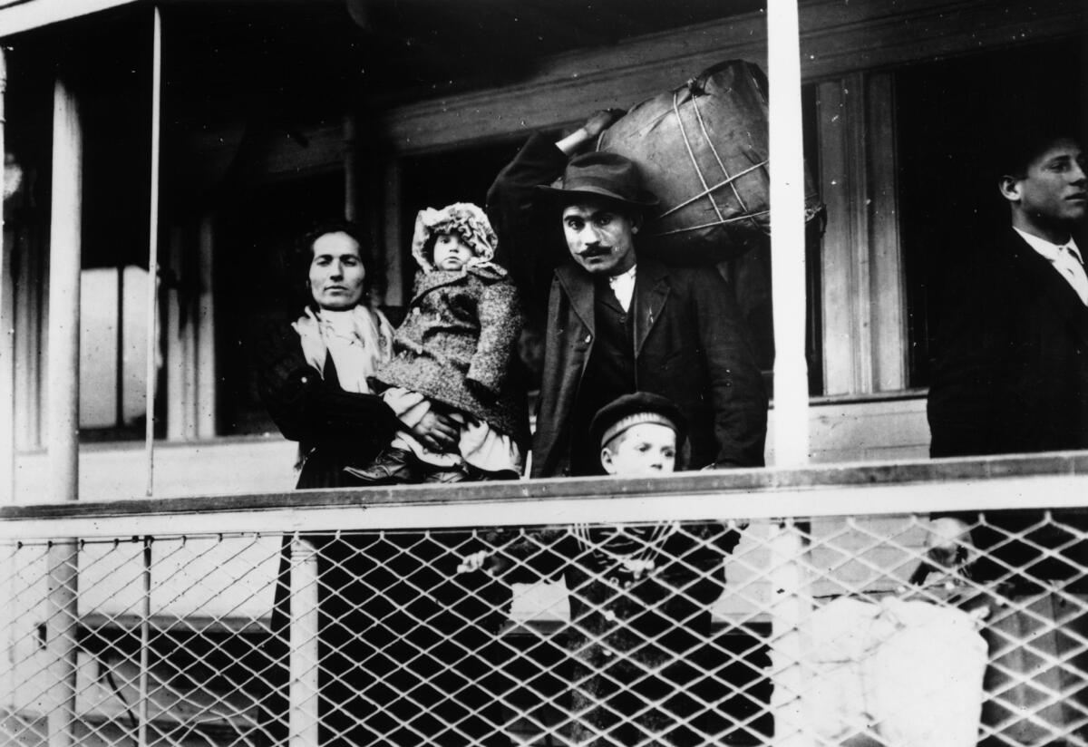 An Italian immigrant family aboard a ferry to Ellis Island, N.Y., circa 1900-1909.