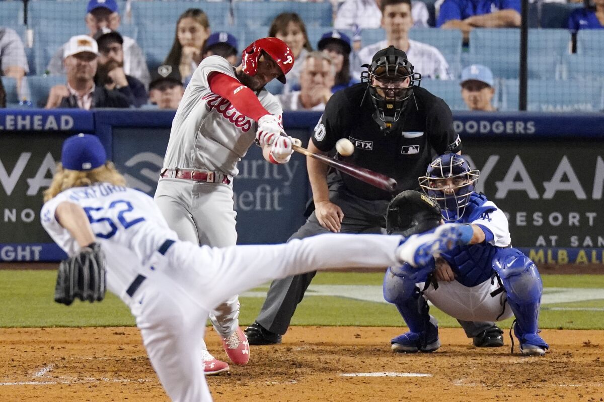 Philadelphia's Bryce Harper hits a solo home run off Dodgers reliever Phil Bickford in the eighth inning.