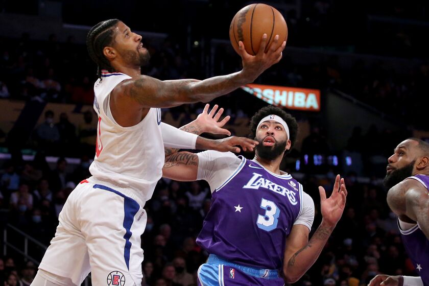 LOS ANGELES, CALIF. - DEC. 3, 2021. Clippers forward Paul George goes to the basket.