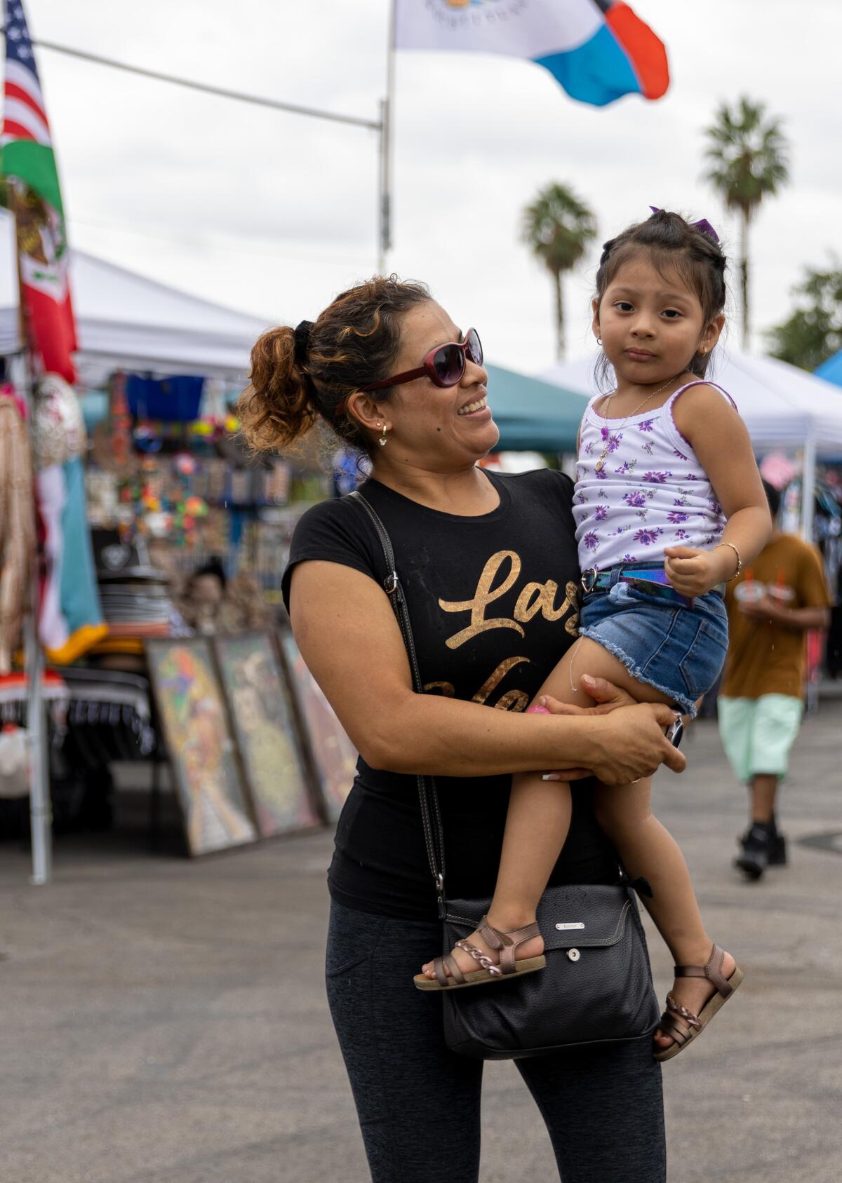 Alma Martinez and daughter Carly Balmaceda dance along to live music during the Fiestas Patrias carnival.