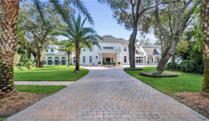The 18,700-square-foot mansion includes nine bedrooms, 13 bathrooms, a movie theater, wine cellar, cigar room and indoor pool.