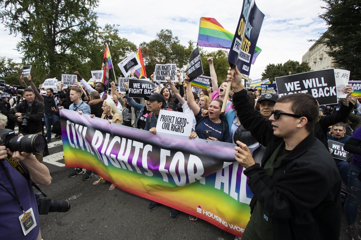 Supporters of LGBTQ rights stage a protest on the street in front of the U.S. Supreme Court in 2019 in Washington.