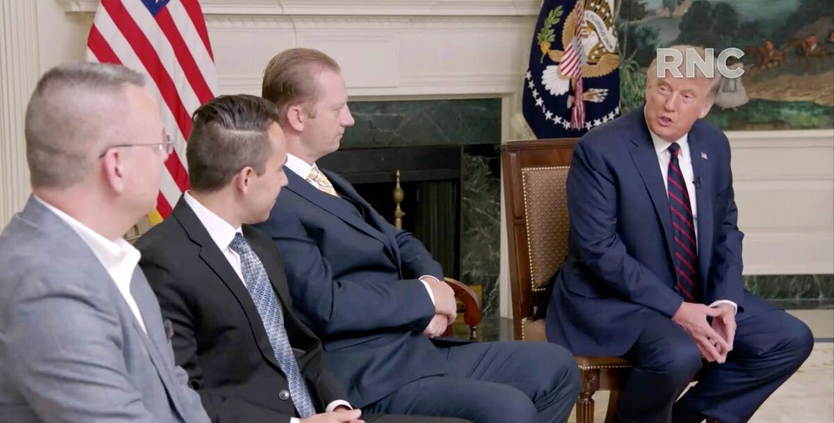 President Trump, right, speaks with freed captives in a prerecorded video broadcast during the Republican convention.