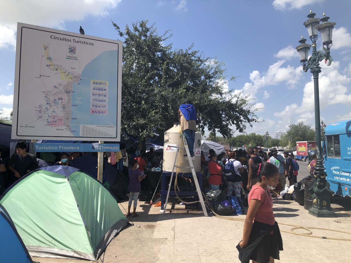 A tourism billboard amid the migrant camp in Reynosa, Mexico.