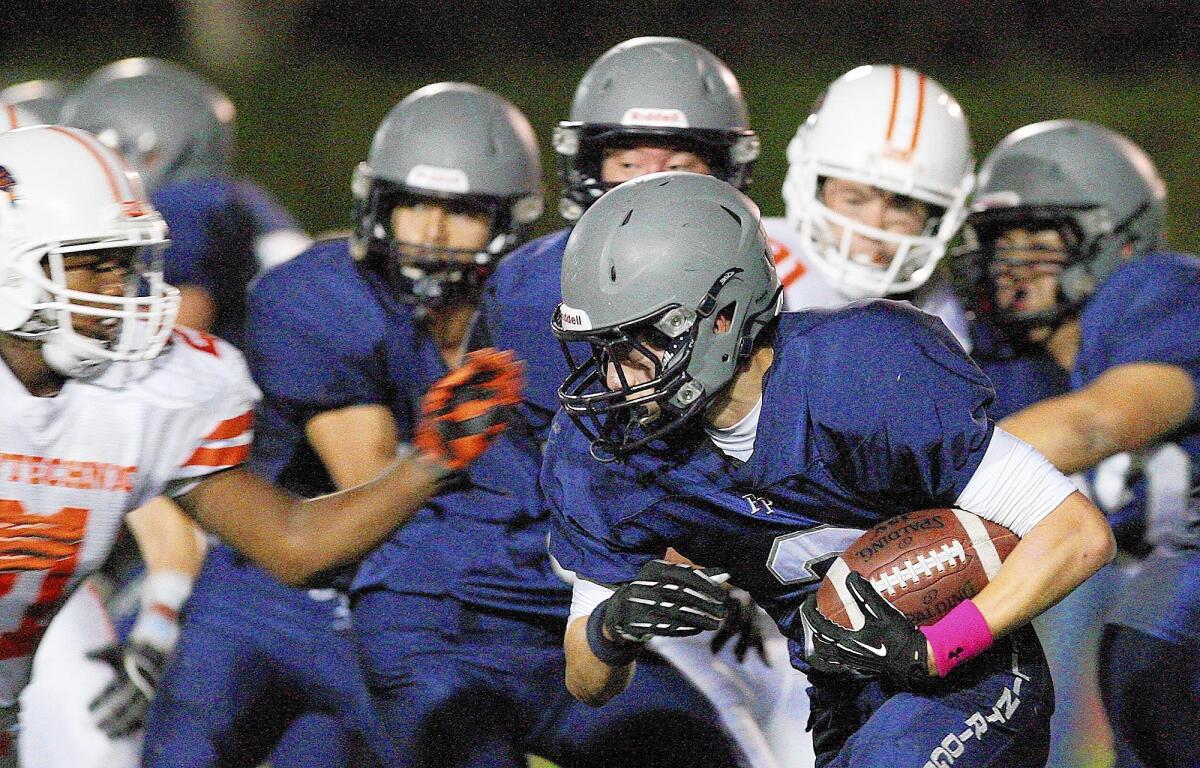 Flintridge Prep's Elliot Witter runs the ball against Pasadena Poly during a game on Friday, October 11, 2013.