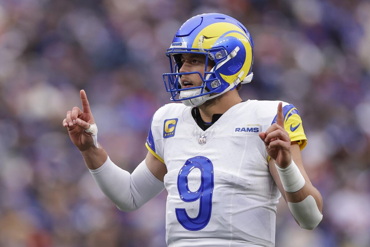 Rams quarterback Matthew Stafford signals during the first half Sunday.