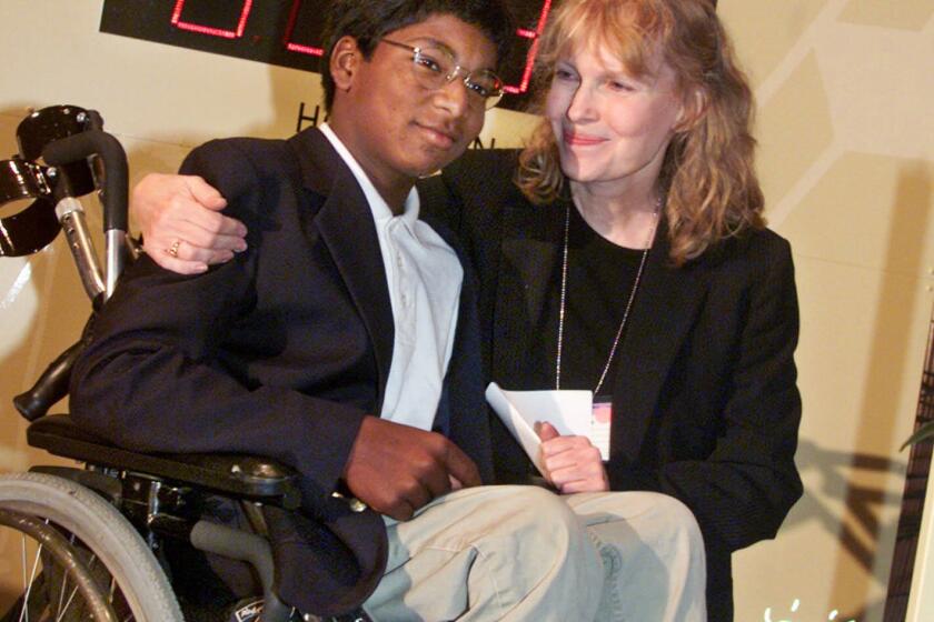 Actress Mia Farrow poses with her son Thaddeus at a global summit on polio eradication at United Nations headquarters on Sept. 27, 2000.