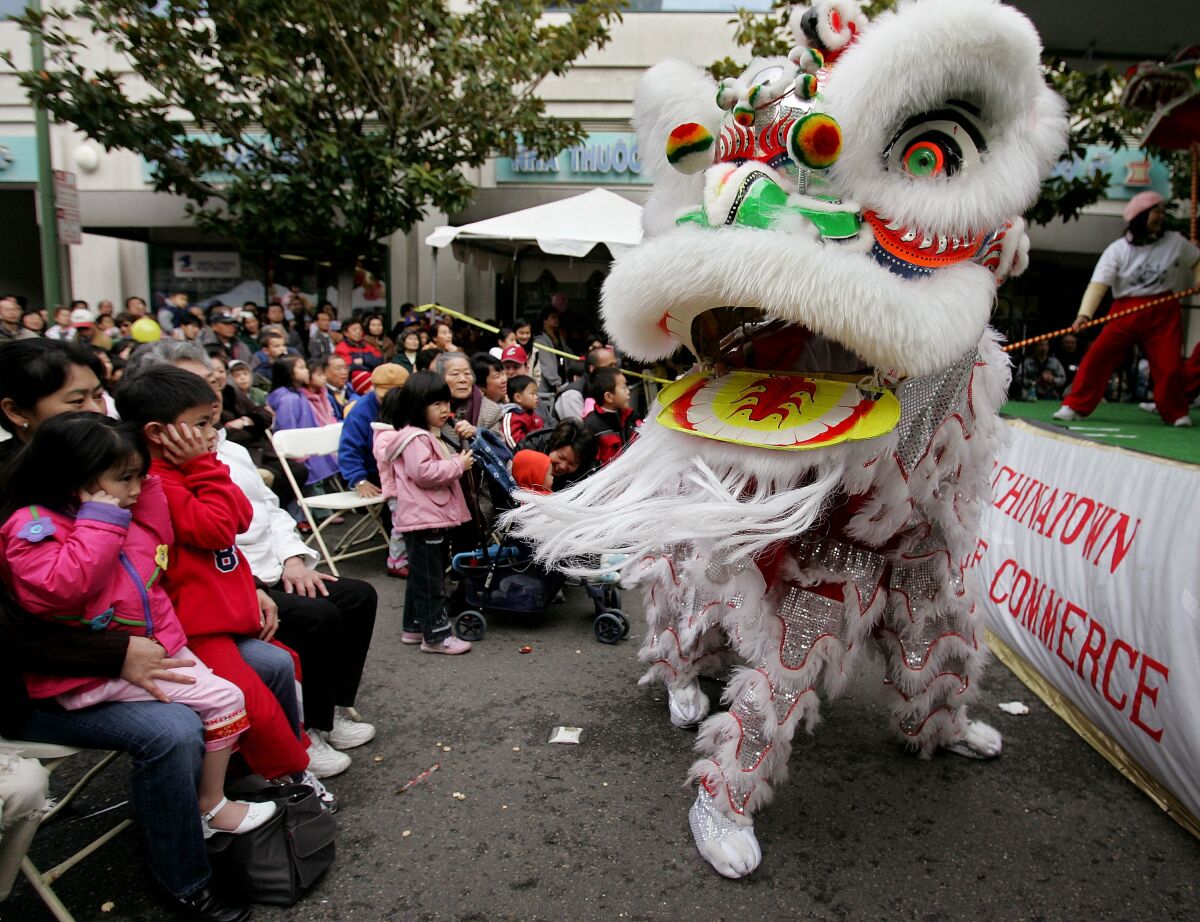 FILE - In this Jan. 21, 2006, file photo, Chinese lion dancers perform in Oakland's Chinatown in Oakland, Calif. According to new data from the U.S. Census Bureau released Thursday, Aug. 12, 2021, California's Asian population grew by 25% in the past decade, making them the fastest growing ethnic group in the nation's most populous state. (AP Photo/Paul Sakuma, File)