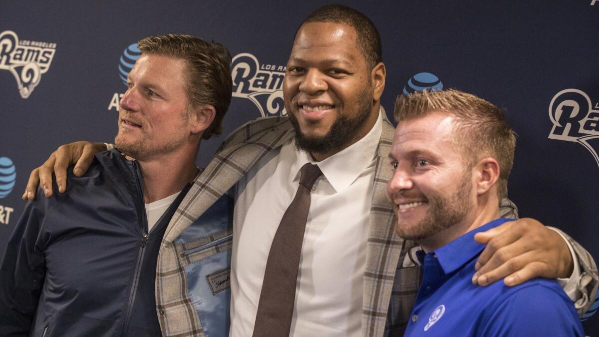 Rams general manager Les Snead, left, and head coach Sean McVay, right, introduce new defensive tackle Ndamukong Suh, center, in Thousand Oaks on Friday.