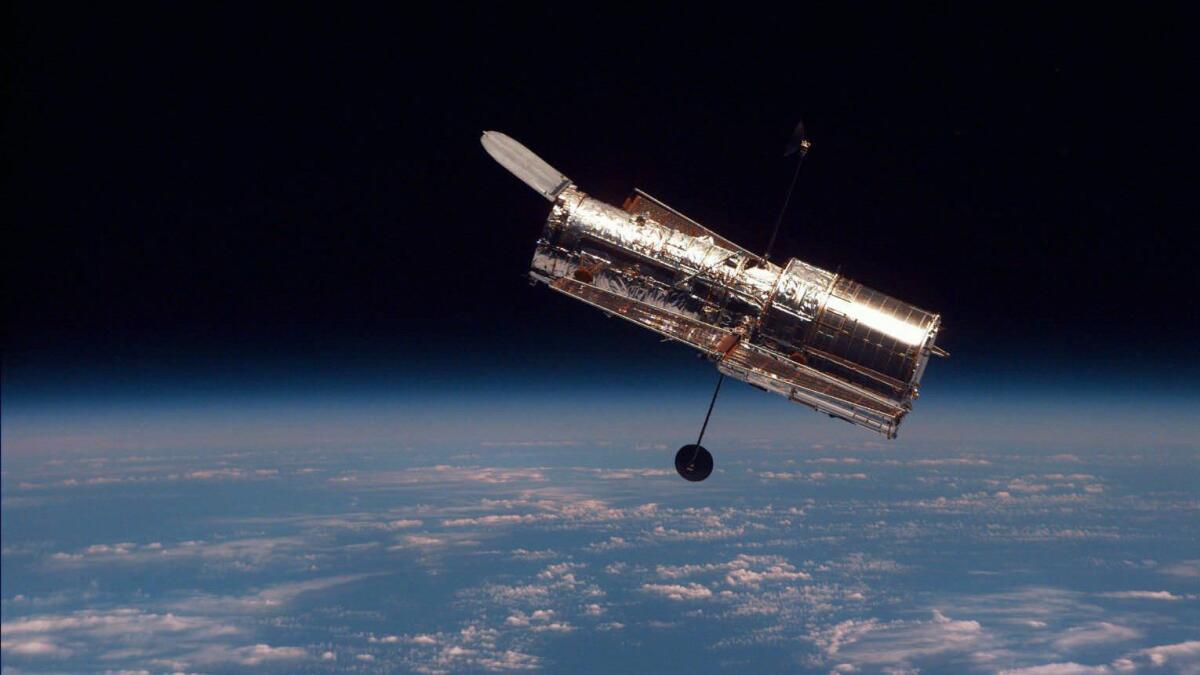 The Hubble Space Telescope is shown following its release from the space shuttle Discovery Wednesday, Feb. 19, 1997. Astronauts made five spacewalks to install two $100-million-plus science instruments and new electronics and data recorders, and to hang homemade patches over tears and cracks discovered in Hubble's insulation. (AP Photo/NASA)