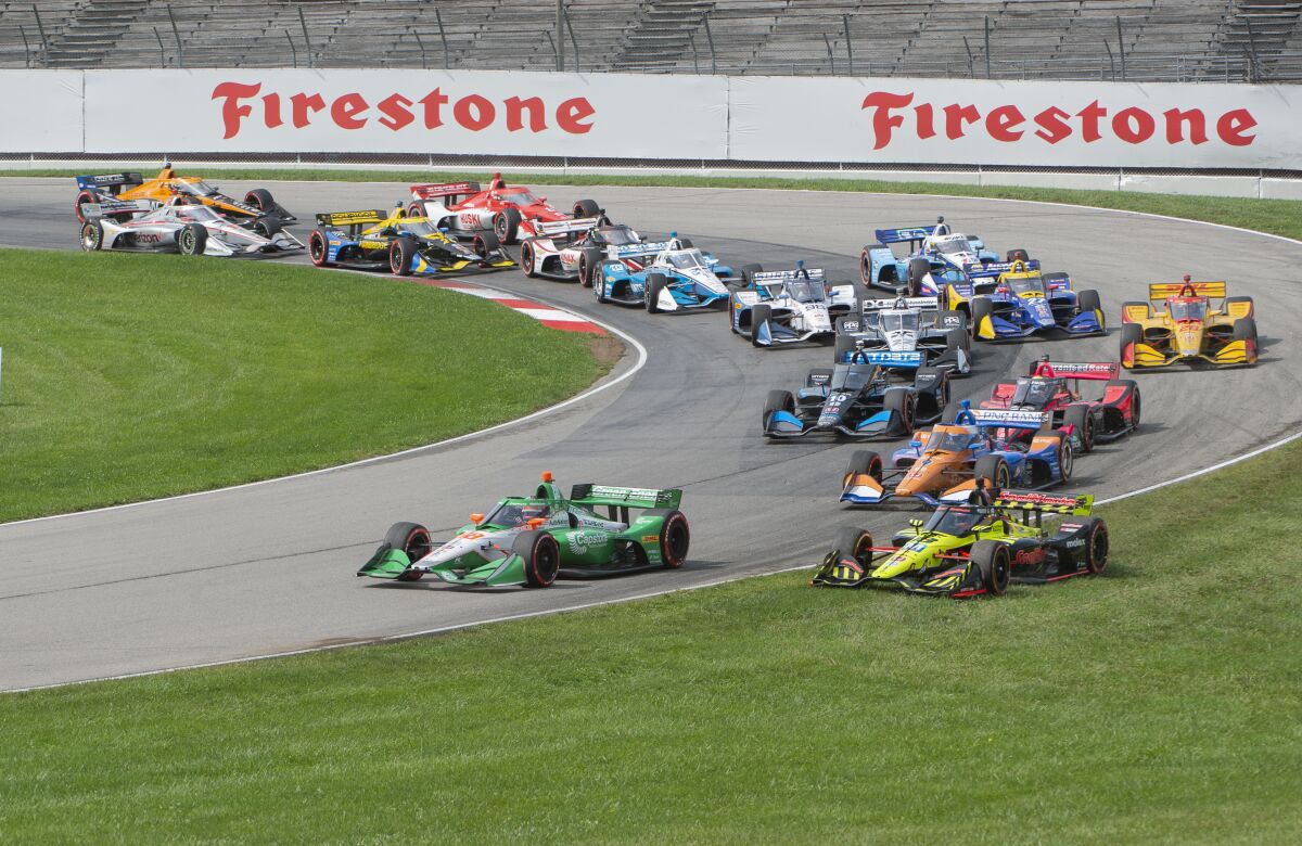 Colton Herta (88) leads the field as Santino Ferrucci (18) runs in the grass during the start of an IndyCar Series auto race at Mid-Ohio Sports Car Course, Sunday, Sept. 13, 2020, in Lexington, Ohio. (AP Photo/Phil Long)