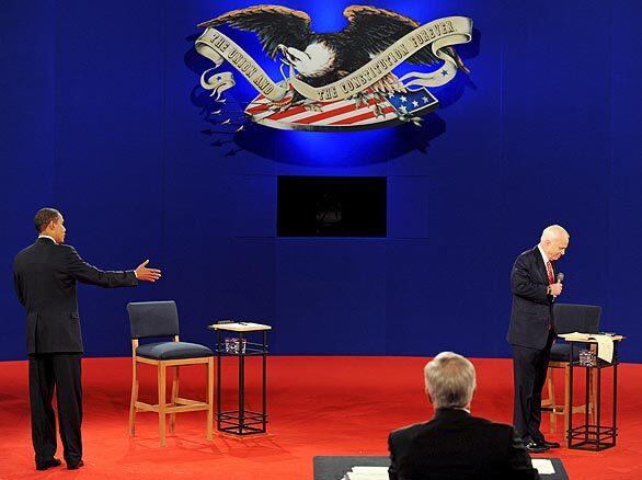 John McCain refers to his notes as Barack Obama takes his turn speaking during the second presidential debate, held at Belmont University in Nashville.