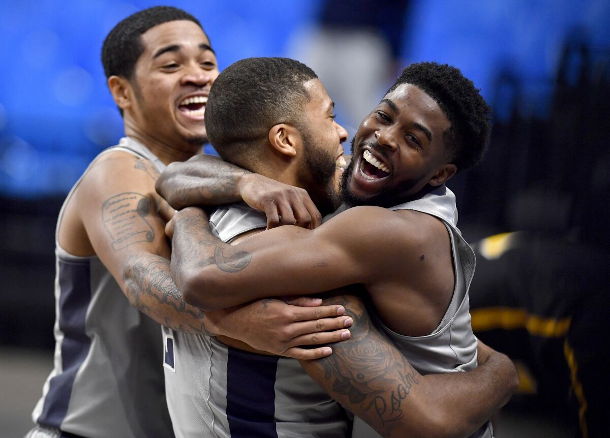 Penn State's Myles Dread is hugged by teammate Jamari Wheeler after his buzzer-beater for the win over VCU during an NCAA college basketball game Wednesday, Dec. 2, 2020, in State College, Pa. (Abby Drey/Centre Daily Times via AP)