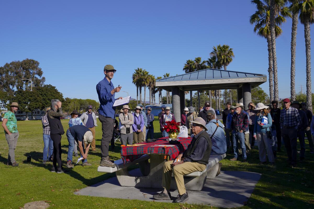 Justyn Stahl gathers with volunteers at a park