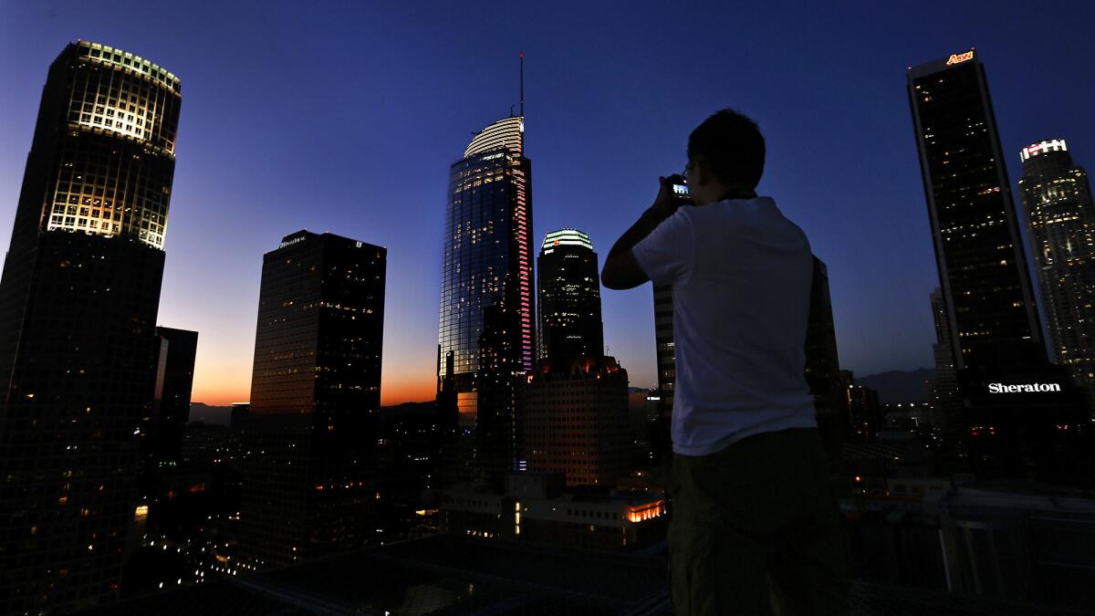 The Wilshire Grand Center, third building from left, is photographed at dusk on June 15, 2017.