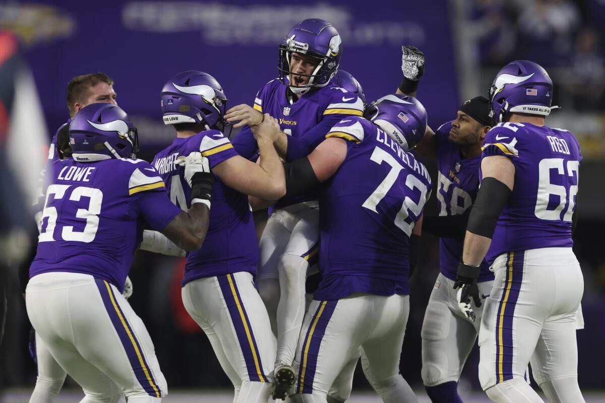 Greg Joseph celebrates with Minnesota Vikings teammates after kicking the winning field goal.