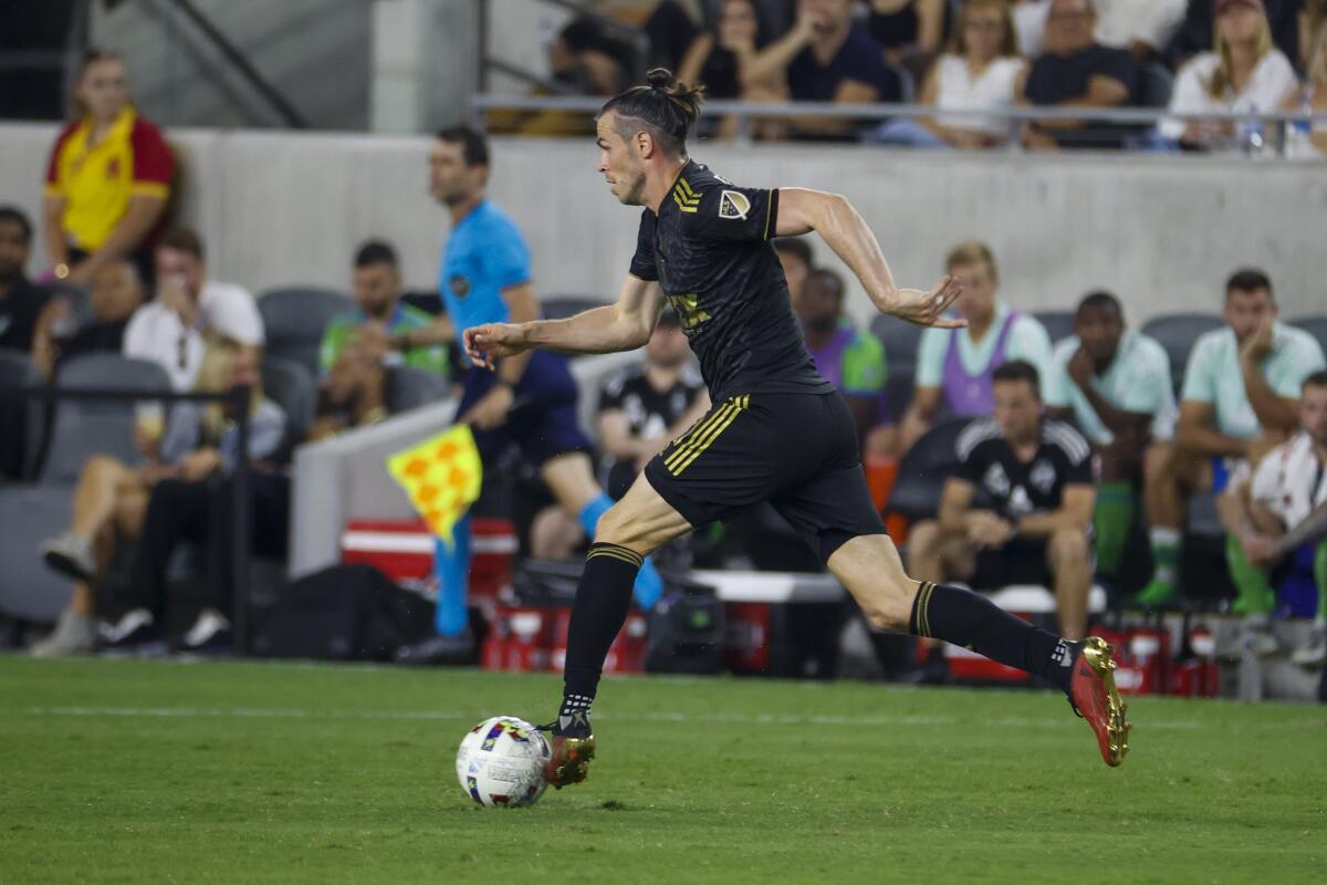 Los Angeles FC forward Gareth Bale (11) drives the ball during an MLS soccer match.