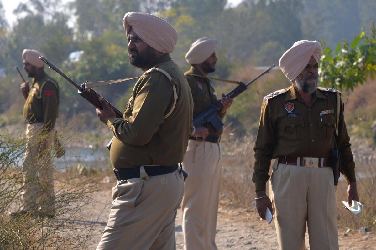 Indian police personnel stand alert near the air force base in Pathankot, India, on Tuesday.