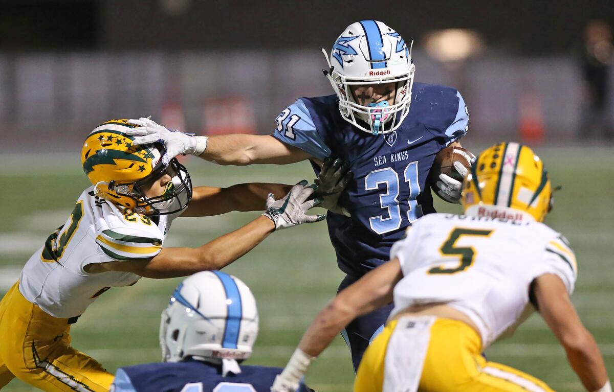 Corona del Mar's Riley Binnquist (31) runs for a first down in a Sunset League game against Edison on Friday at Newport Harbor High.