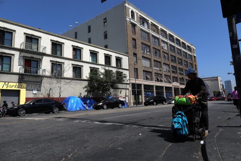 LOS ANGELES, CALIF. -- TUESDAY, JULY 16, 2019: The Historic Catalina building, right, has been repurposed for restaurants, distribution, retail, industrial and creative office space located at 443 South San Pedro Street in Los Angeles, Calif., on July 16, 2019. Community leaders and homeless advocates held a press conference in response to the Los Angeles Department of City Planning’s rezoning of Skid Row, at LA Can. This marks the launch of a campaign to prevent the displacement of homeless people, which is being led by the Skid Row Now and 2040 Coalition – a coalition of community organizations, neighborhood activists, and social services providers. (Gary Coronado / Los Angeles Times)