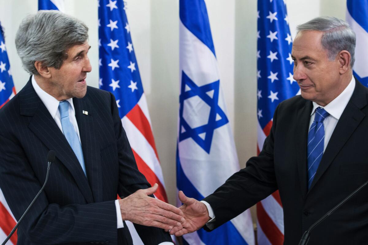 U.S. Secretary of State John Kerry, left, and Israeli Prime Minister Benjamin Netanyahu shake hands before a meeting at the prime minister's office in Jerusalem.