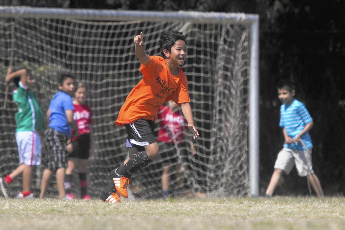 Davis’ Jonathan Cheng celebrates after scoring against Whittier during the boys’ 5-6 Gold Division championship game of the Daily Pilot Cup Sunday afternoon.