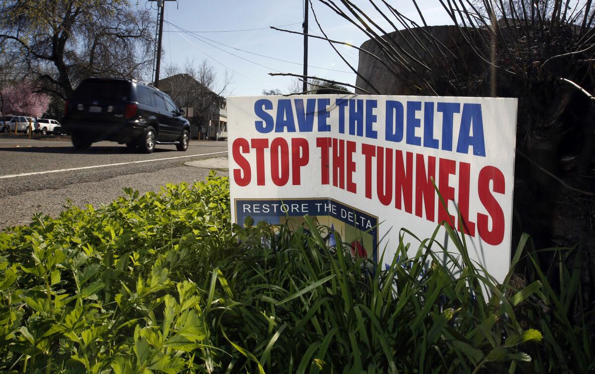 A sign by a road says, "Save the delta, stop the tunnels."