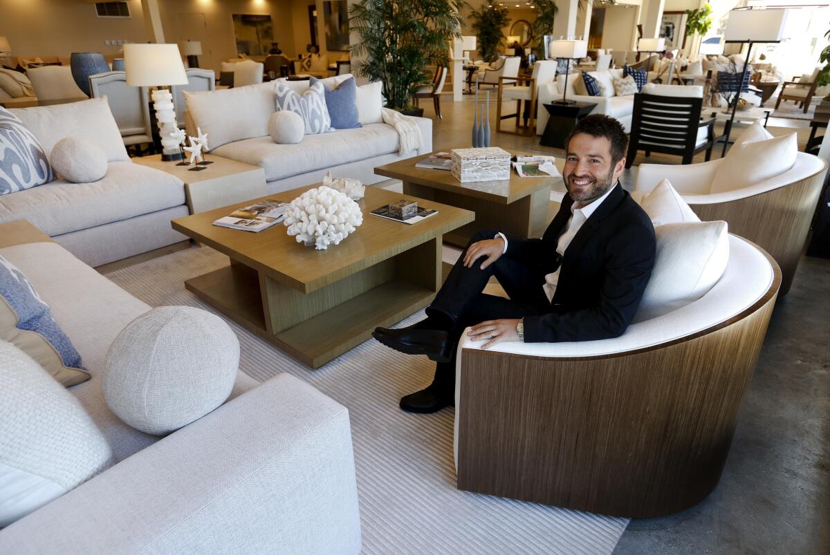 Loren Kreiss, CEO and creative director of Kreiss Furniture, sitting on a mambo swivel chair made out of rift walnut that is part of the Azul collection.