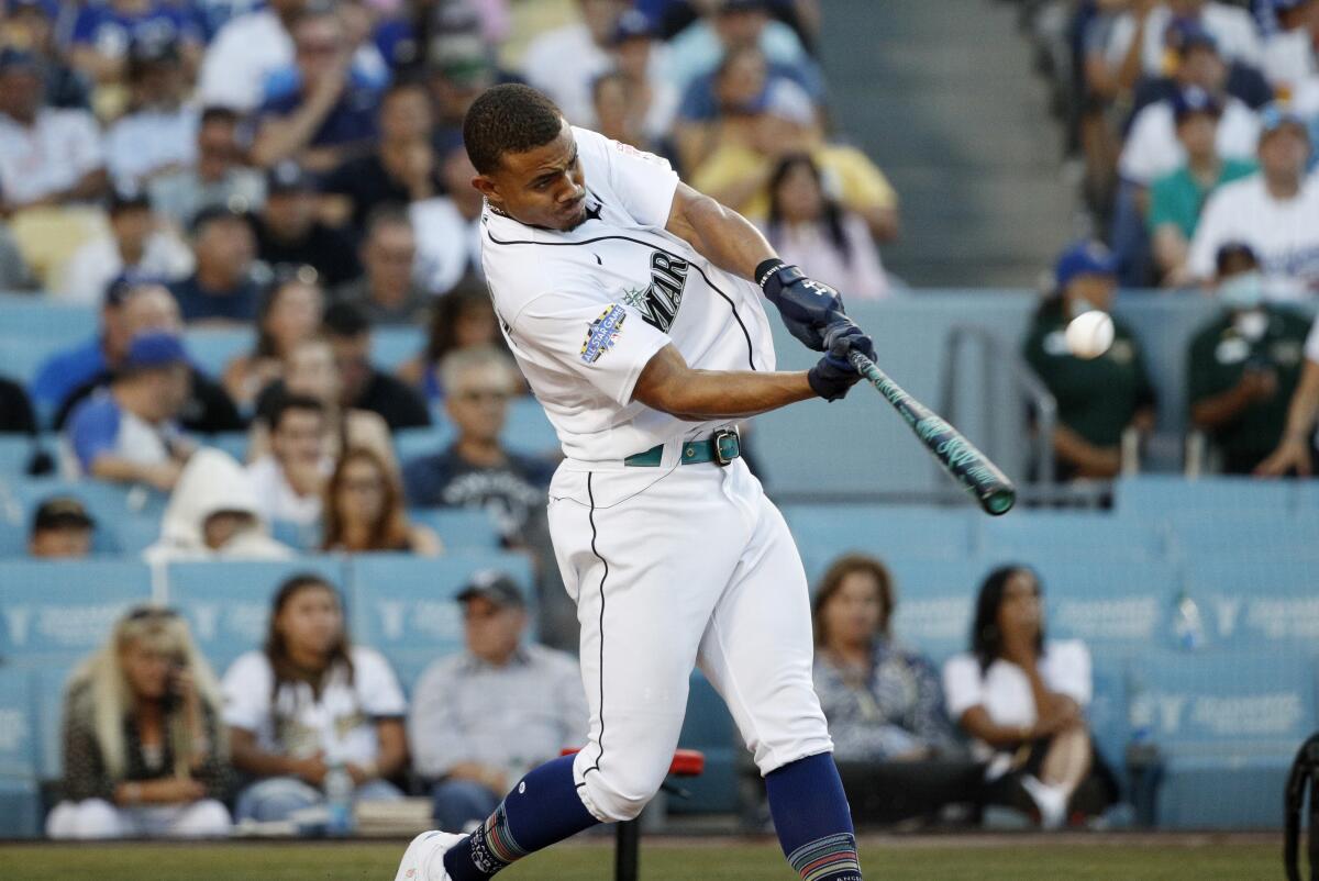Seattle Mariners' Julio Rodríguez connects for a home run in the finals of the Home Run Derby.