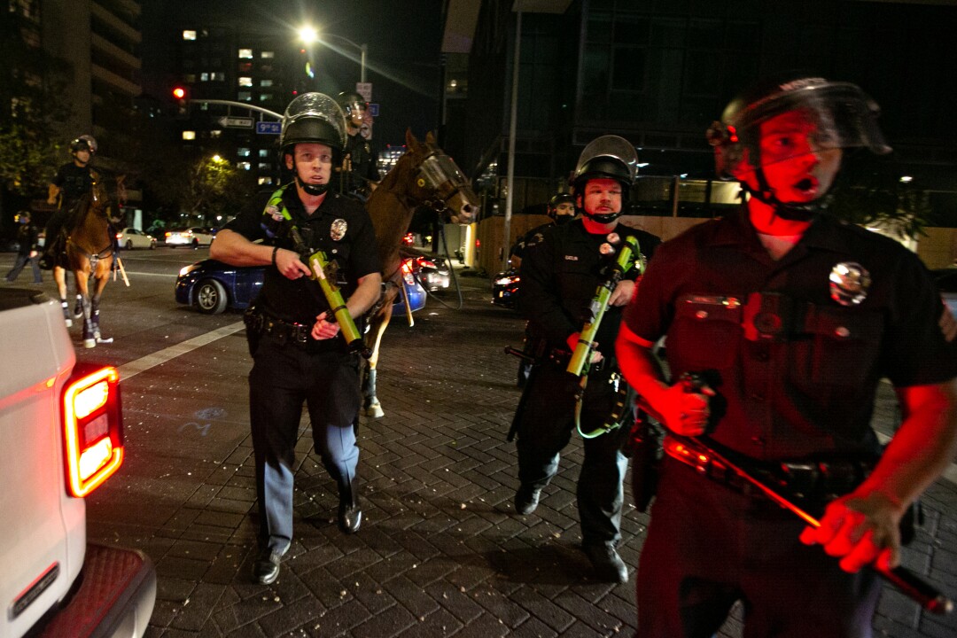 Police disperse crowds in downtown Los Angeles celebrating the Dodgers winning the World Series.