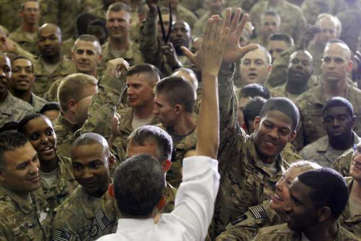 President Obama greets U.S. troops during a predawn stop at Bagram air base, north of Kabul. In 2008, Obama could run as an antiwar candidate, but that¿s hard to do as commander in chief of a military engaged in combat ¿ and one who dramatically increased drone strikes.