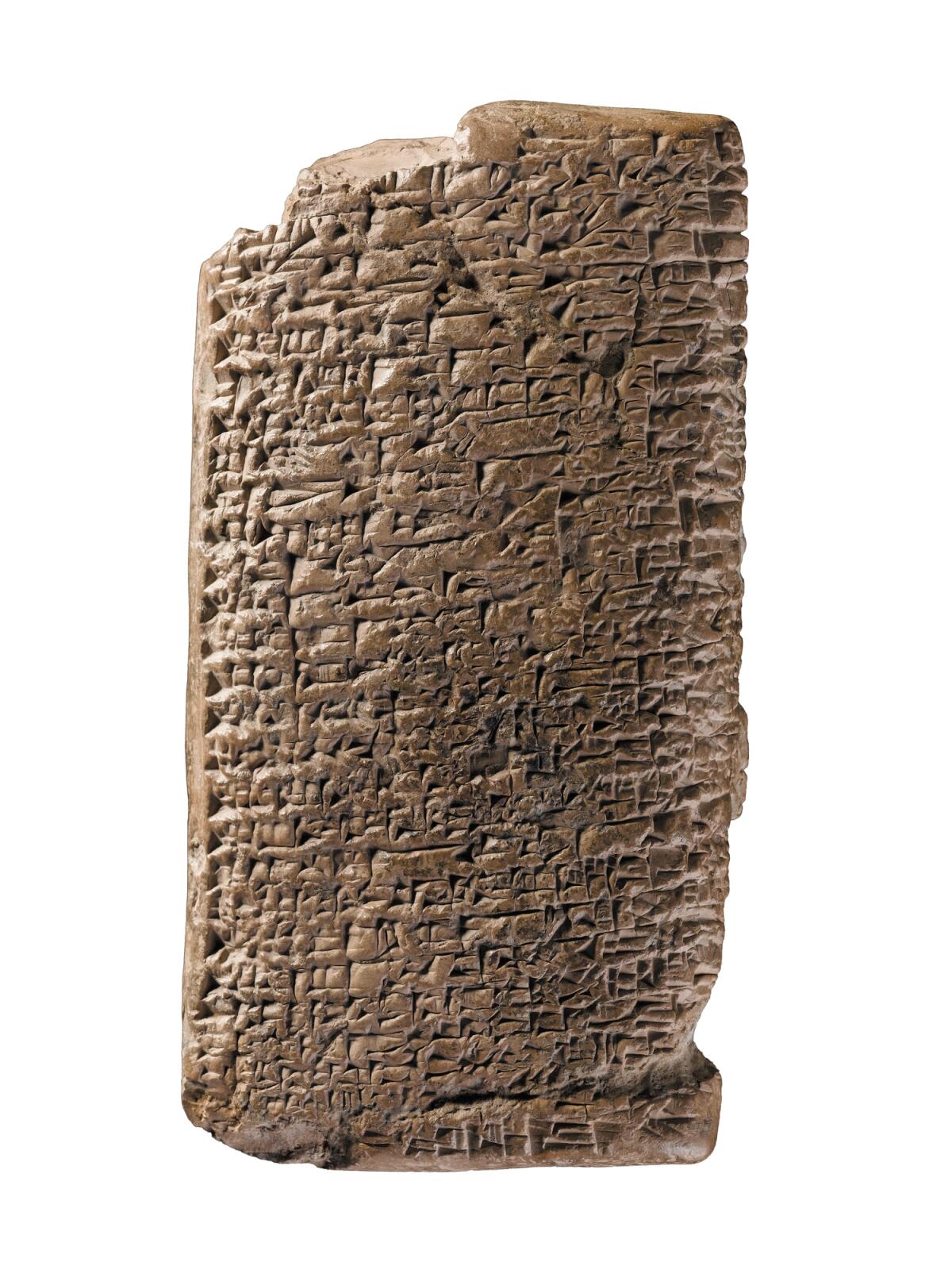 A terra cotta tablet covered in cunieform writing.