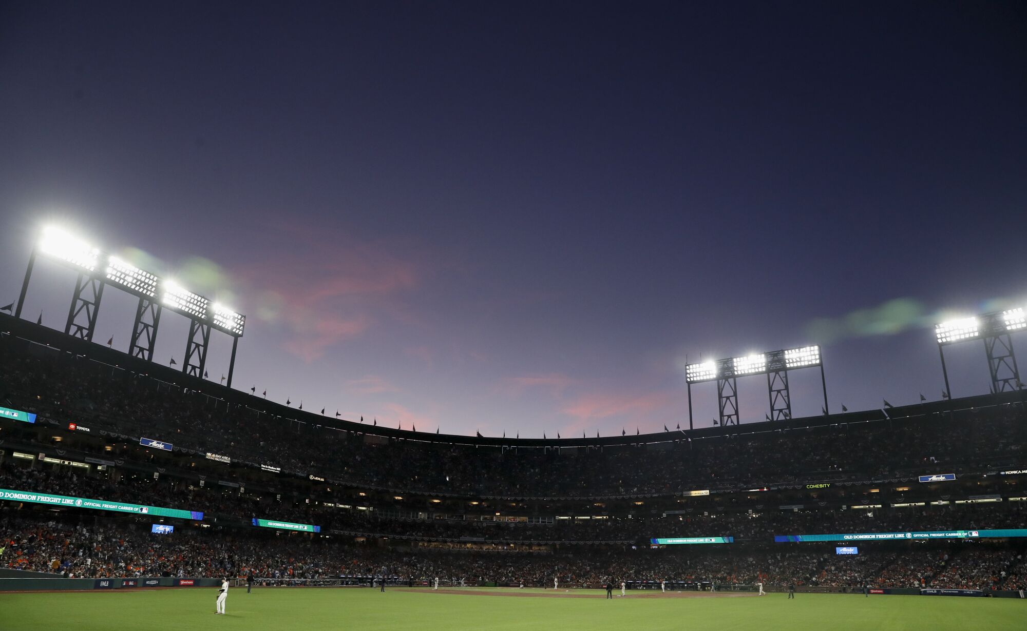 The sun sets behind the stands at Oracle Park