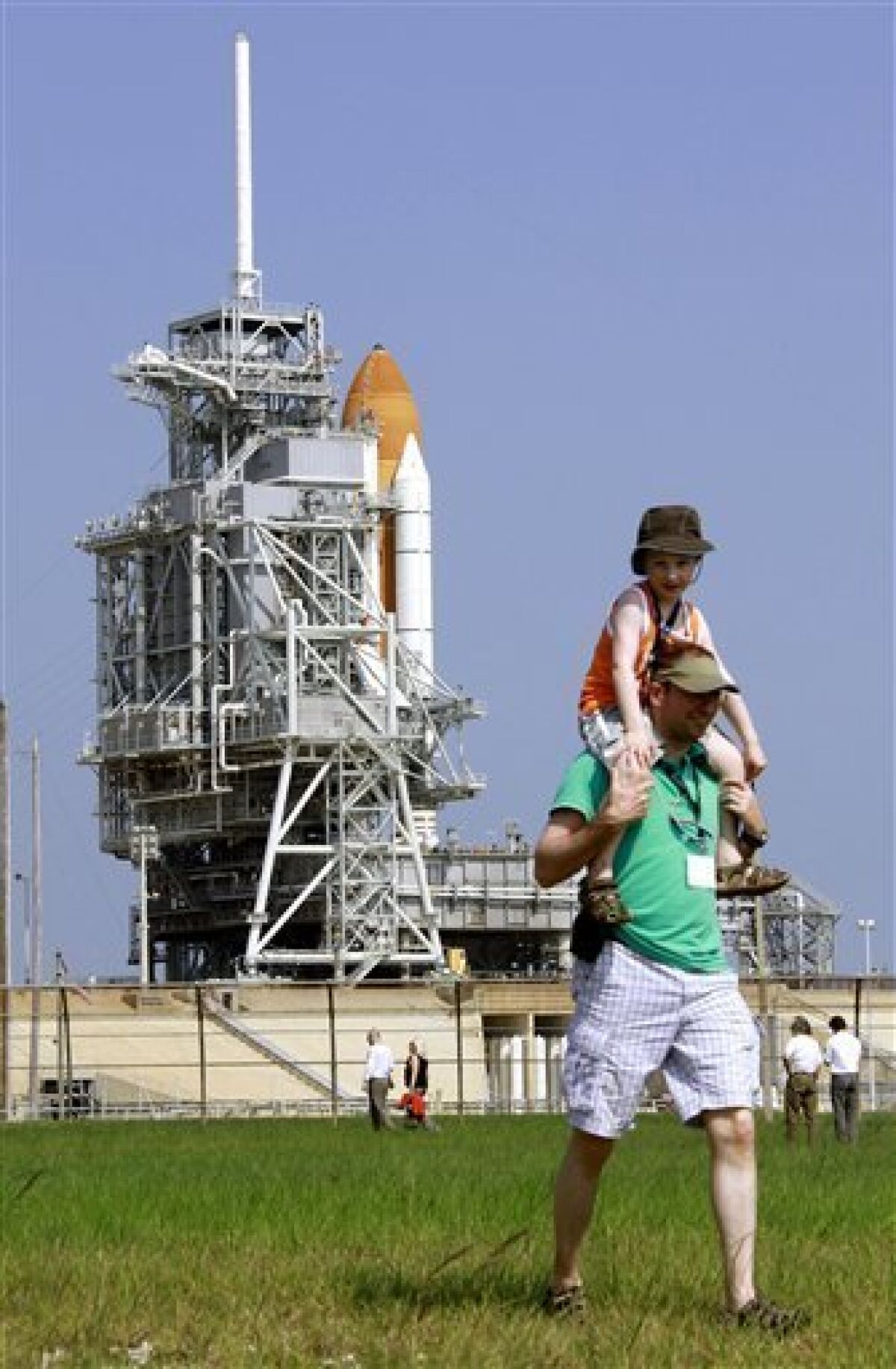 Five-year-old Thomas Pittson, of Montreal, Canada, gets a ride on his father Nick's shoulders as they walk near the space shuttle Endeavour Thursday June 11, 2009 at the Kennedy Space Center in Cape Canaveral, Fla. Seven astronauts are scheduled to liftoff early Saturday morning for a trip to the international space station. (AP Photo/Terry Renna)
