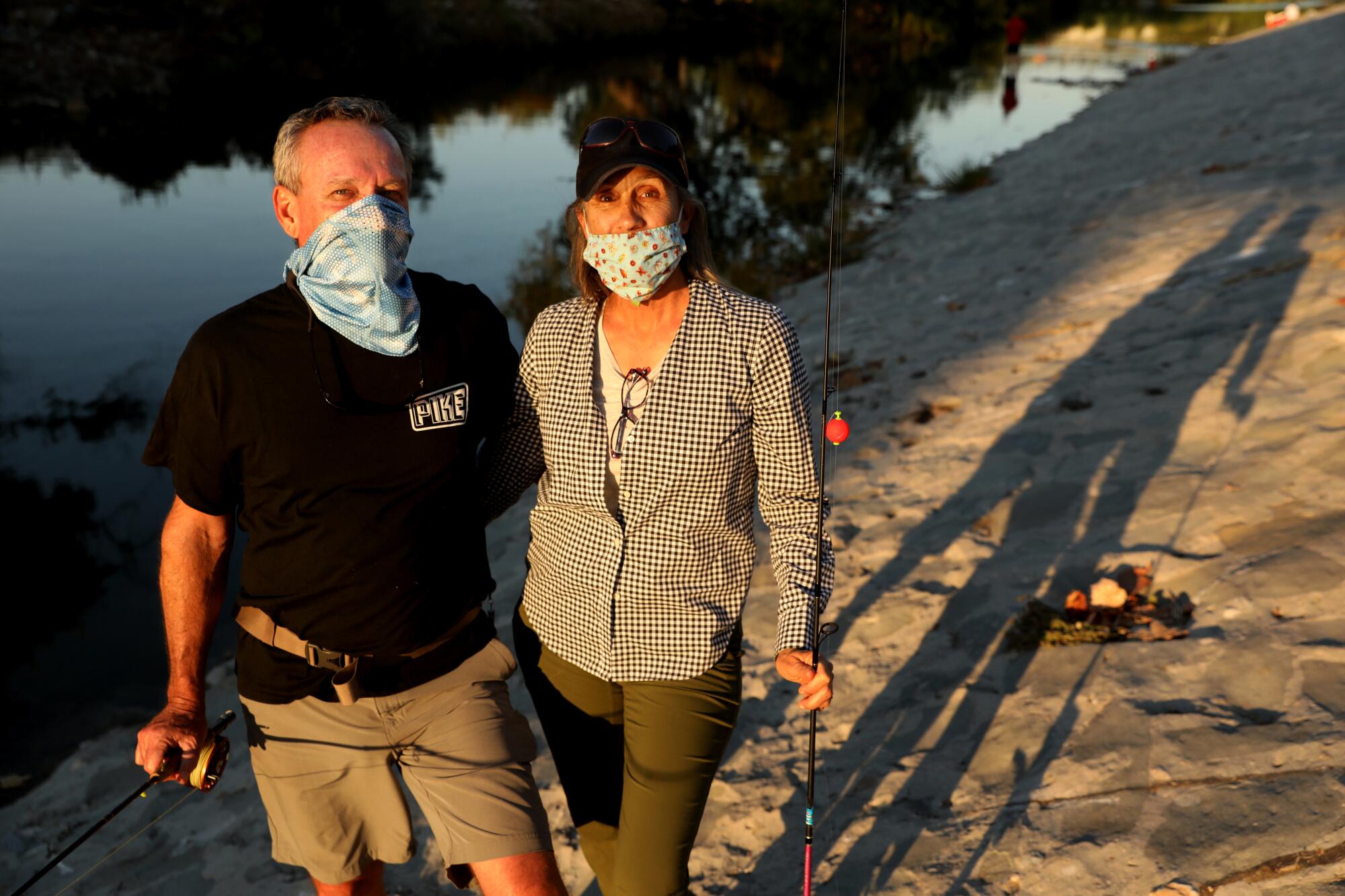 Bob Blankenship and Karen Barnett wear masks on a recent trip to the L.A. River