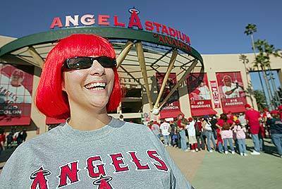 Los Angeles Angels fan Reshae Calderon stands in front of Angel Stadium as she waits to enter for opening day.