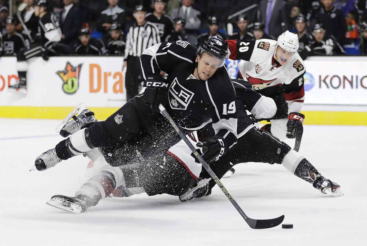 Kings' Brett Sutter takes a tumble after he was slashed by Arizona Coyotes' Jakob Chychrun during the second period of a preseason game in Los Angeles.